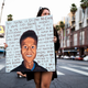A person holds a sign at a candlelight vigil to demand justice for Elijah McClain on the one year anniversary of his death on August 24, 2020 in West Hollywood, California.